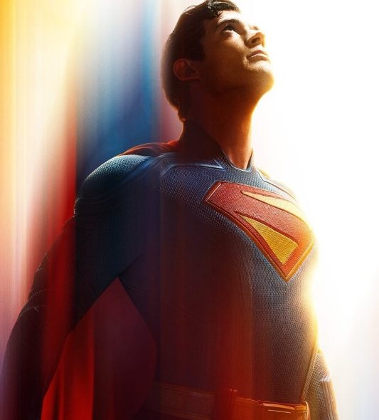 Superman, in his iconic blue and red suit with the S-shield, looks up intensely against a backdrop of glowing red, orange, and blue light streaks, conveying motion and power.