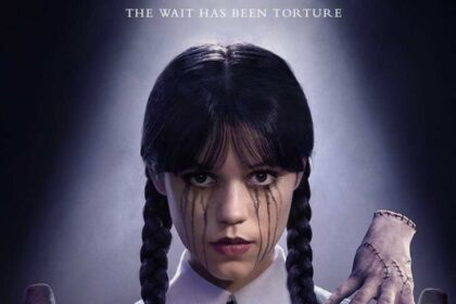 Wednesday Addams (Jenna Ortega) on the official Season 2 poster, tied with Thing on her shoulder, looking unimpressed.