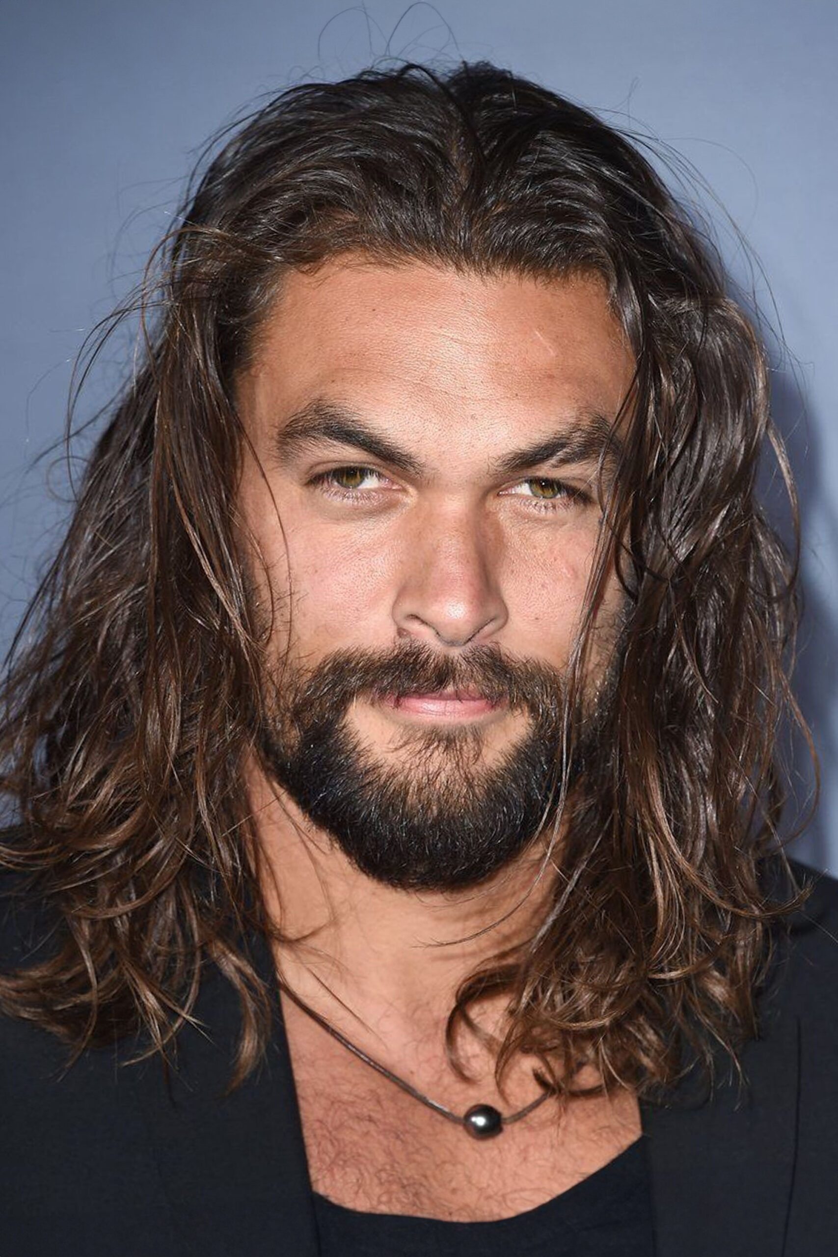 A headshot of Jason Momoa.